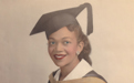 A picture of a young Judge Mary Lowe '54 in her graduation cap and gown