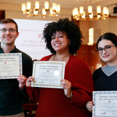 Three students holding up certificates from Brooklyn Law School.